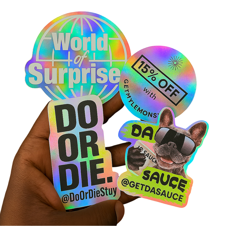 Hand holding a stack of custom holographic die-cut vinyl stickers